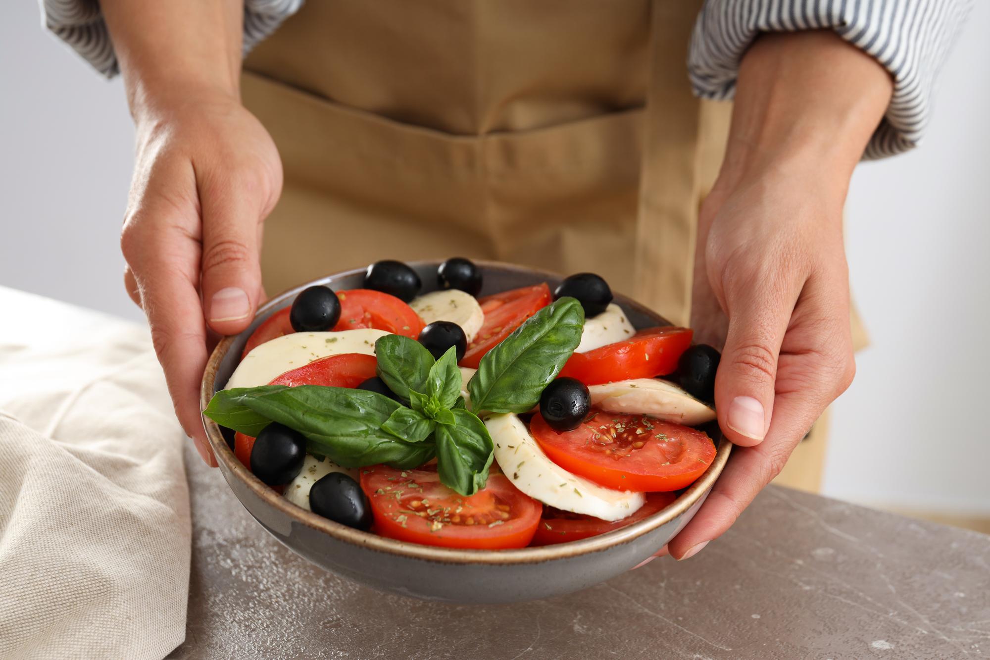 Founder arranging plated vegetables on a wooden counter